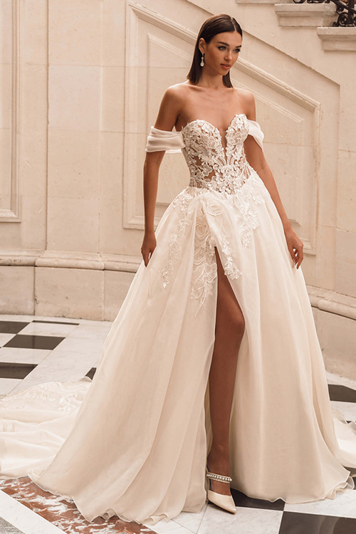 Front view of the ÉLYSÉE Fuchsia ballgown with sweetheart neckline, floral lace bodice, and high slit. Front view of the ÉLYSÉE Fuchsia ballgown with sweetheart neckline, floral lace bodice, and high slit.