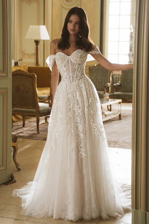 Front view of the ÉLYSÉE Gail A-line gown with sweetheart neckline, floral lace bodice, and detachable straps. Front view of the ÉLYSÉE Gail A-line gown with sweetheart neckline, floral lace bodice, and detachable straps.