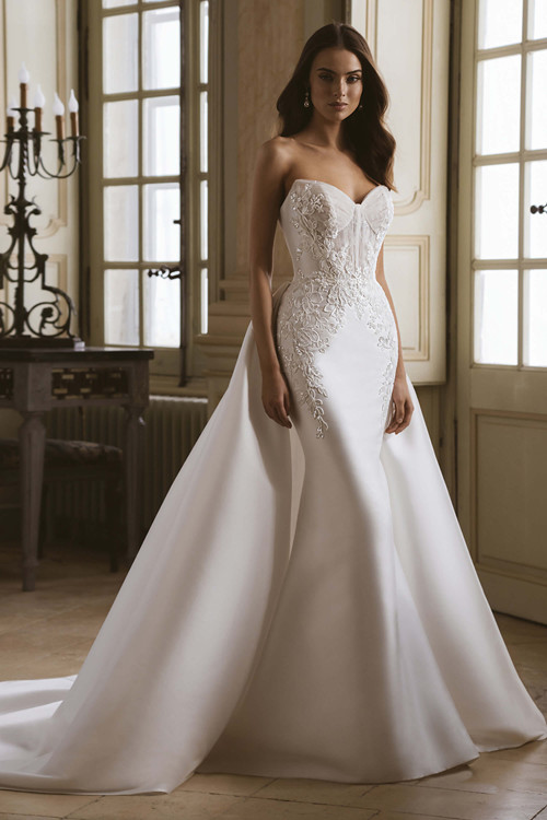 Front view of the ÉLYSÉE Gala gown styled with detachable overskirt, sweetheart neckline, and floral lace bodice. Front view of the ÉLYSÉE Gala gown styled with detachable overskirt, sweetheart neckline, and floral lace bodice.