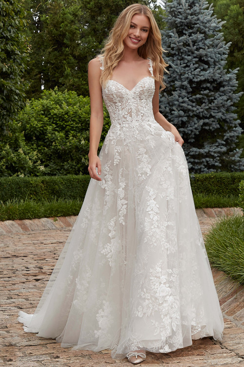 Front view of Morilee Primula A-line gown with floral embroidered appliqués. Front view of Morilee Primula A-line gown with floral embroidered appliqués.