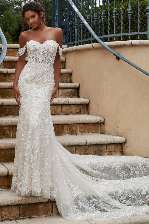 Front view of Morilee Philomena fit-and-flare gown with lace appliqués and chapel train. Front view of Morilee Philomena fit-and-flare gown with lace appliqués and chapel train.