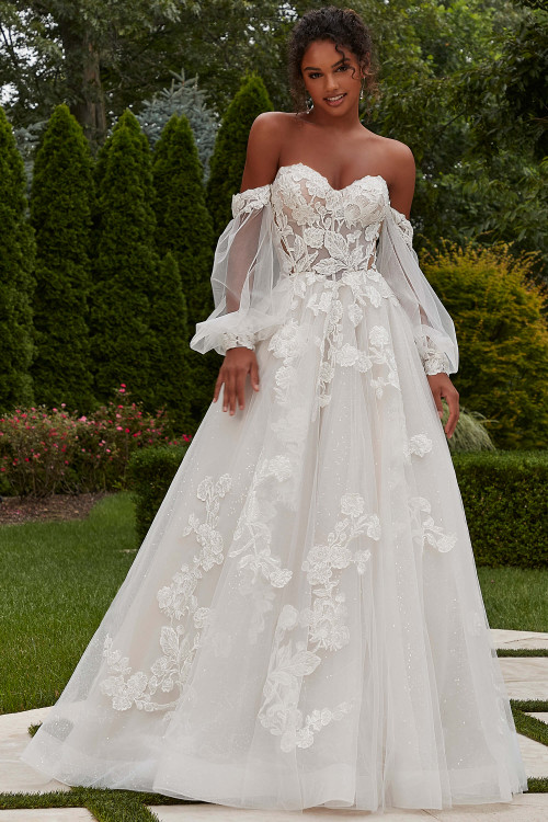 Front view of Morilee Primrose ball gown with lace appliqués and detachable sleeves. Front view of Morilee Primrose ball gown with lace appliqués and detachable sleeves.