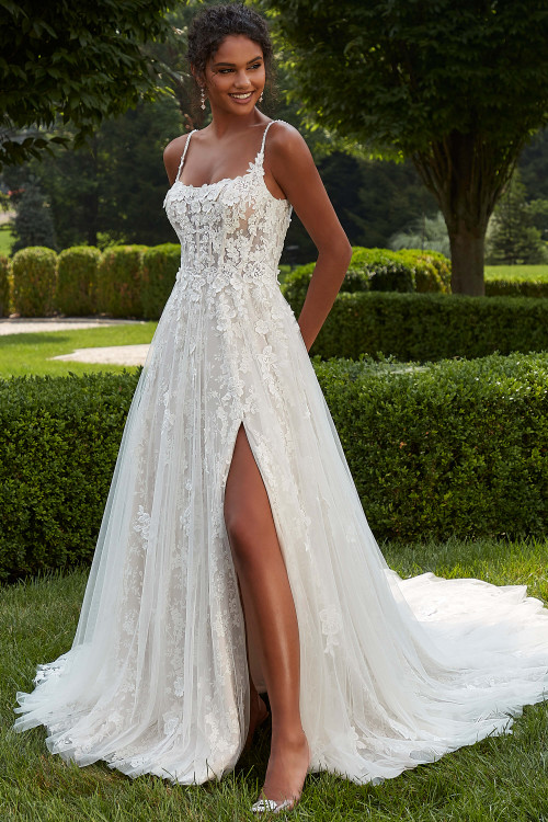 Front view of Morilee Palmina A-line gown with thigh-high slit and lace appliqués. Front view of Morilee Palmina A-line gown with thigh-high slit and lace appliqués.