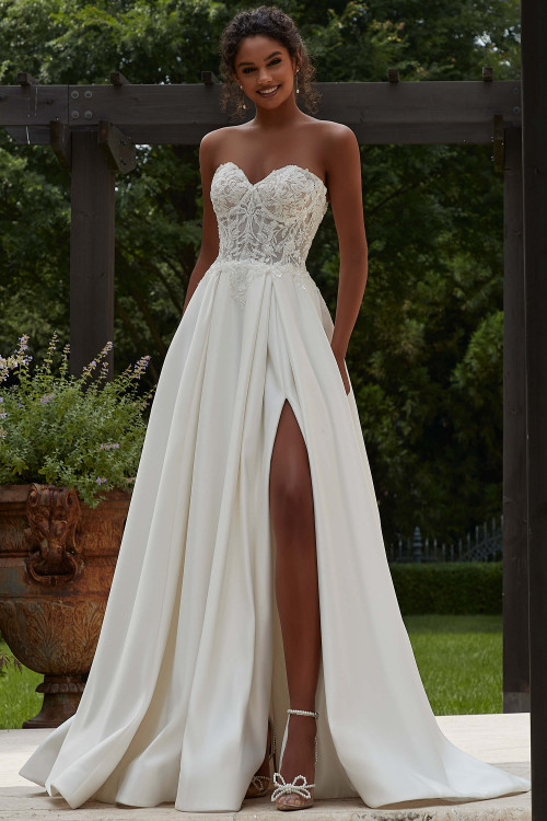 Front view of Morilee Patricia A-line gown with lace bodice and thigh-high slit. Front view of Morilee Patricia A-line gown with lace bodice and thigh-high slit.