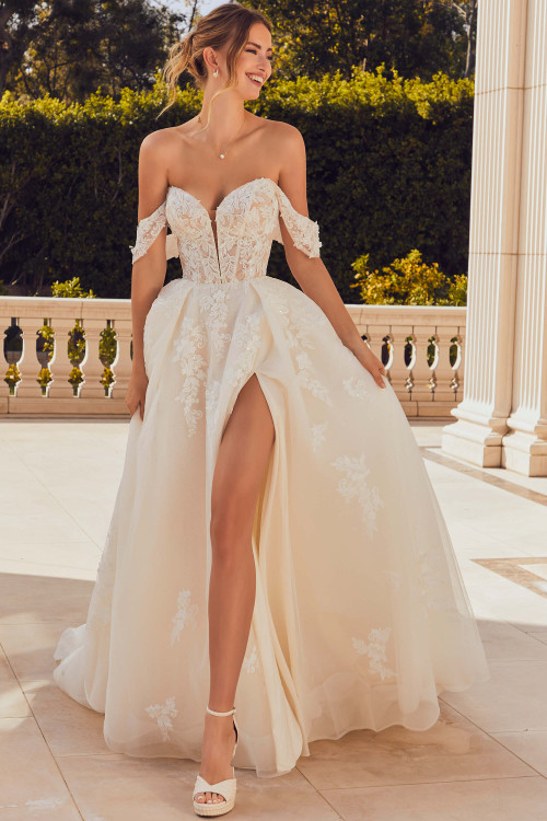 Front view of Morilee Renata A-line gown with thigh-high slit and corset bodice. Front view of Morilee Renata A-line gown with thigh-high slit and corset bodice.