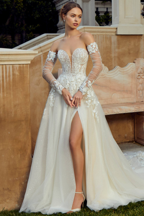 Front view of Morilee Raphaella A-line gown with high slit and floral appliqués. Front view of Morilee Raphaella A-line gown with high slit and floral appliqués.