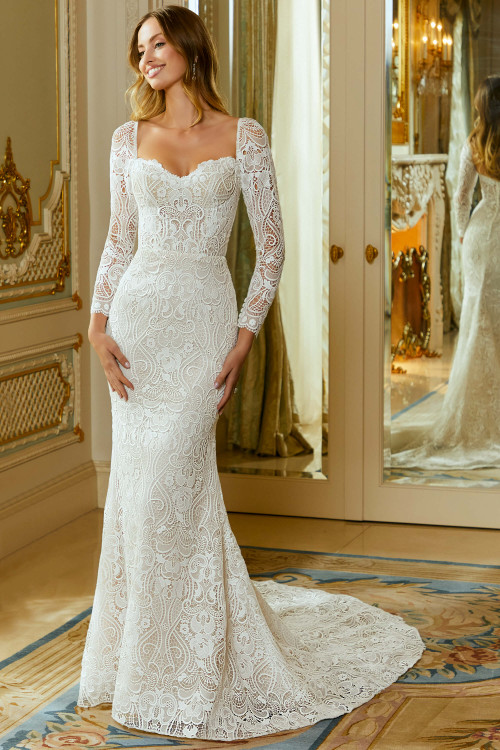 Front view of Morilee Rhapsody sheath gown with lace appliqués and long sleeves. Front view of Morilee Rhapsody sheath gown with lace appliqués and long sleeves.