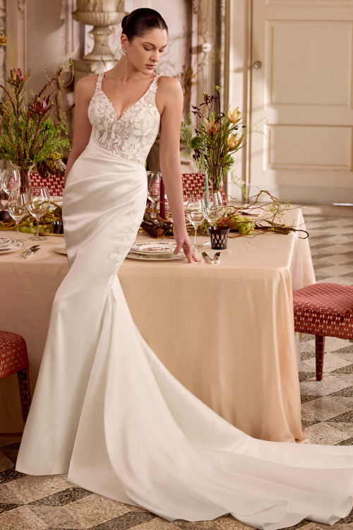 Justin Alexander Laine fit and flare wedding gown in ivory mikado with V-neckline and asymmetrical pleated waist.