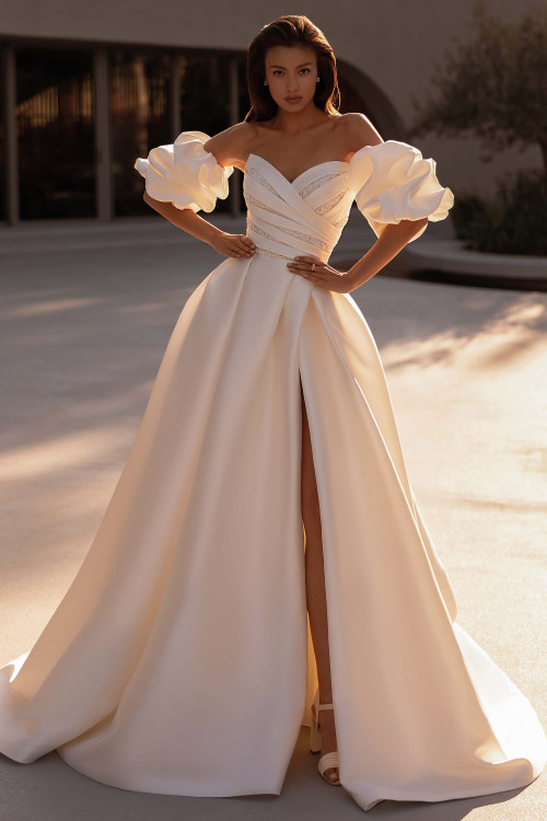 Demetrios Style 1520 A-line wedding dress with beaded ruched bodice, statement sleeves, and flowing Mikado skirt.