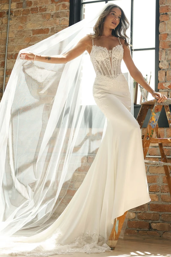 Front view of Maggie Sottero India fitted lace and satin wedding dress with veil