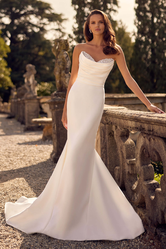 Sleek satin gown with a draped bodice and shimmering sweetheart neckline Sleek satin gown with a draped bodice and shimmering sweetheart neckline
