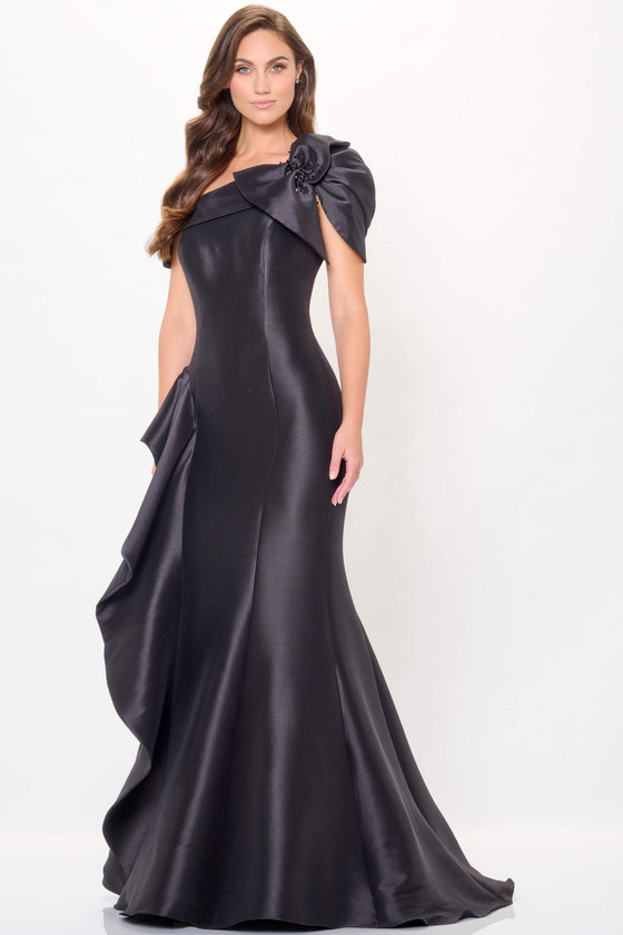 Bold black mermaid silhouette with oversized ruffle shoulder and asymmetric neckline