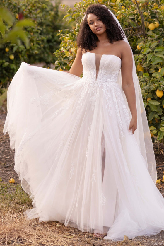 Ethereal tulle gown with floral appliqués, illusion plunge, and flirty slit