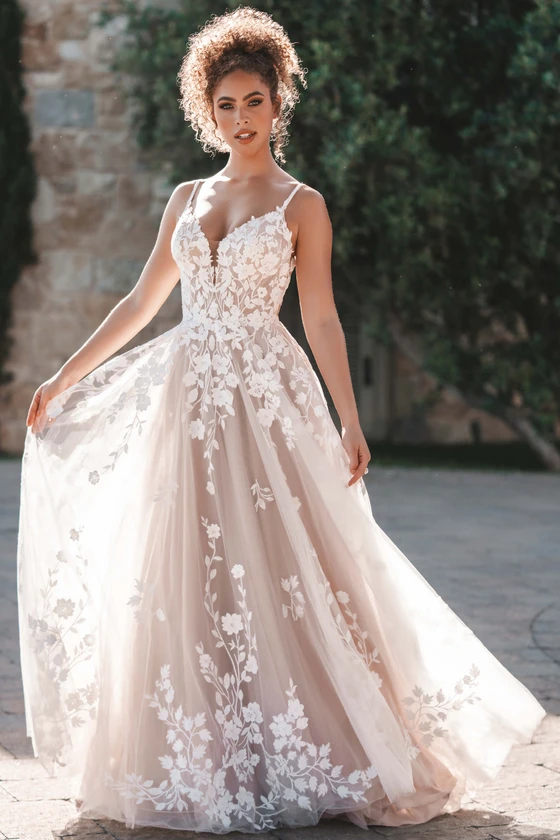 Three-quarter view of A1215 dress showing lace appliques and tulle skirt