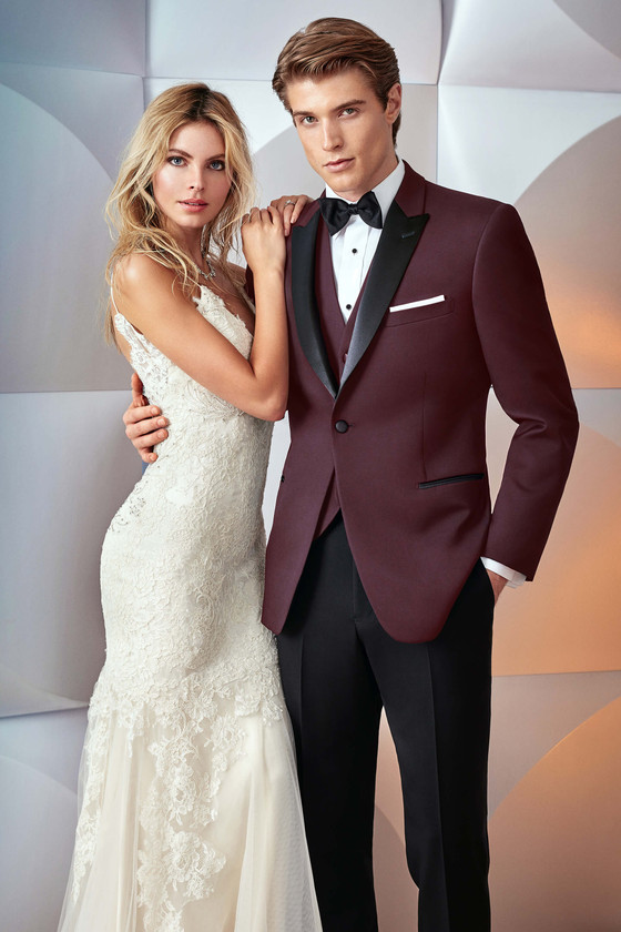 groom with a slim fit burgundy tuxedo jacket