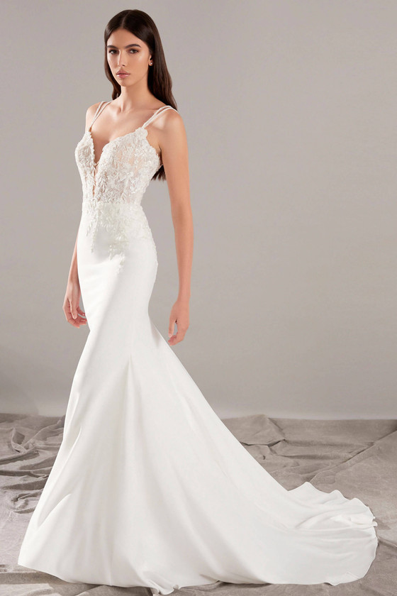 A sheer lace bodice meets a sleek flared skirt in this effortlessly modern bridal silhouette A sheer lace bodice meets a sleek flared skirt in this effortlessly modern bridal silhouette