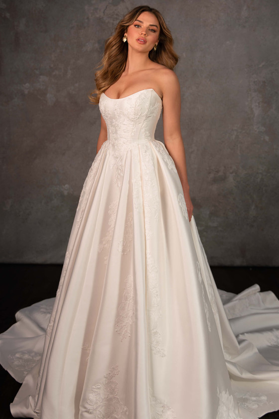 Strapless mikado gown with optional floral embroidery and a structured pleated skirt Strapless mikado gown with optional floral embroidery and a structured pleated skirt