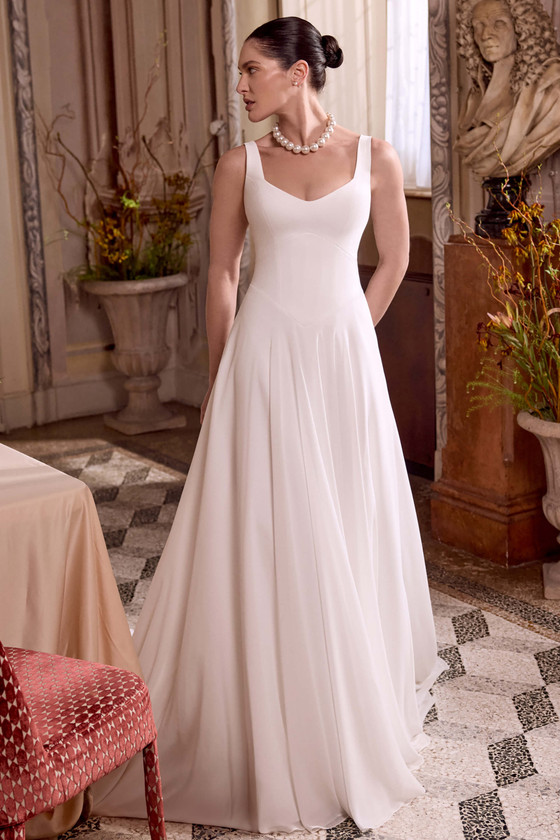 Justin Alexander Lupita A-line wedding gown with scoop neckline, basque waist, and flowing ivory chiffon skirt.