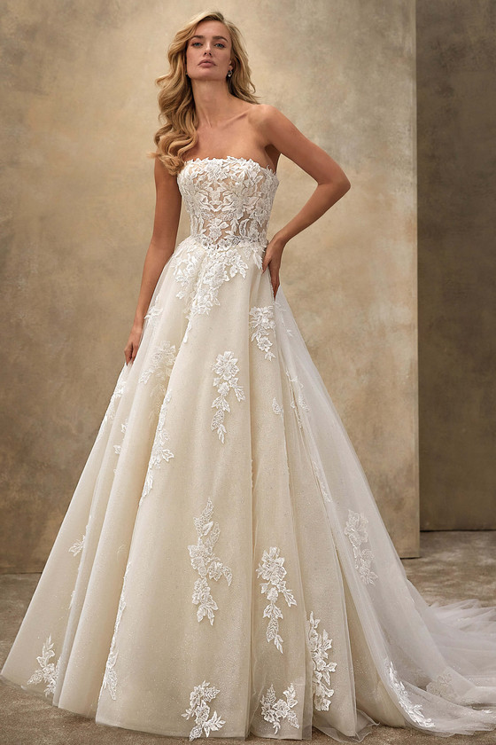 Demetrios Style 1542 strapless A-line wedding dress with structured corset bodice, floral beaded lace, and sparkling tulle.