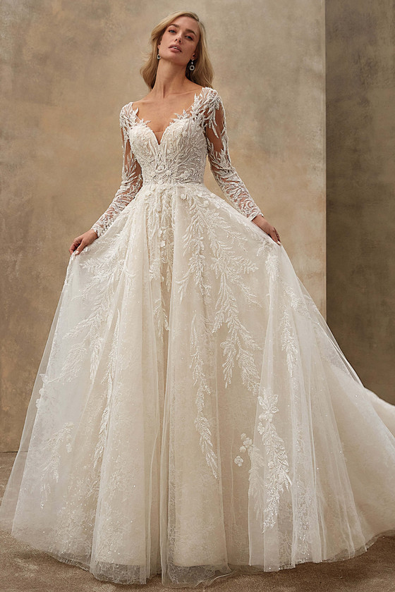 Demetrios Style 1546 ball gown wedding dress with plunging V-neckline, sheer long sleeves, and beaded lace bodice.