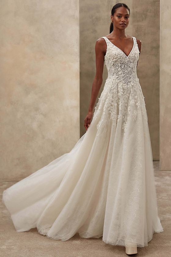 Demetrios Style 1547 A-line wedding dress with petal-shaped V-neckline, beaded lace, and softly flared tulle skirt.