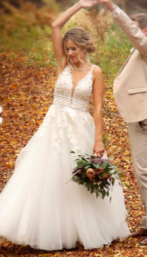 Groom spins bride in leaves