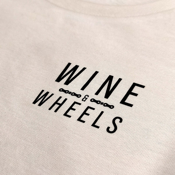 Close-up of Wine & Wheels t-shirt design with bike chain graphic