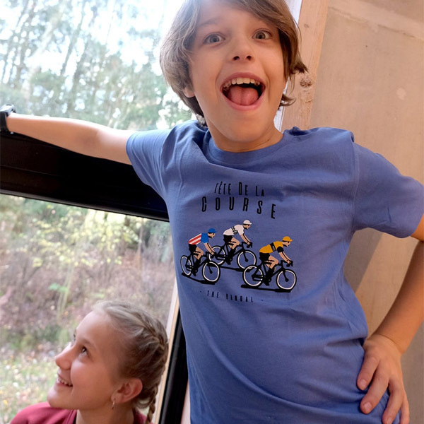 Excited boy wearing a cycling-themed t-shirt with a playful expression