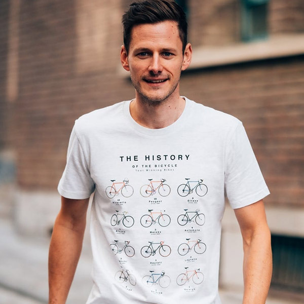 Man wearing a History of the Bicycle t-shirt, showcasing different bike types