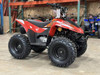 The image showcases the Kayo Storm 70, a compact and stylish youth ATV designed for riders aged 6 and above. The ATV features a sleek white body with bold branding, highlighting its modern design. The image captures the ATV’s sturdy frame, robust tires, and ergonomic seat, emphasizing its suitability for young riders. The front and rear hydraulic disc brakes, as well as the non-adjustable suspension system, are visible, showcasing the ATV’s focus on safety and performance. The electric ignition system and air-cooled engine are also highlighted, making it clear that this ATV is built for ease of use and reliability. The image is set against a natural backdrop, suggesting the ATV’s capability to handle off-road adventures.