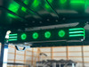 A close-up of the Premium Evolution Sound Bar shows its compact design with built-in speakers and woofers. The adjustable LED light modes sync with the music, creating a vibrant and immersive audio experience. The sound bar is wirelessly connected to the touchscreen, offering seamless control over your entertainment.