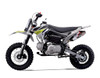 Thumpstar TSK 90cc mini bike, featuring its sleek mini stealth plastics, compact frame, and bold design. The bike is displayed in an action-ready stance, highlighting its inverted front suspension, oversized disc brakes, and Pipe Bomb muffler. The wrap-around frame and waterproof wiring are subtly visible, emphasizing the bike’s durability. The image also highlights the adjustable throttle limiter and emergency lanyard kill switch, key safety features for junior riders.