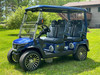 Evolution D-MAX GT4 luxury electric golf cart with forward-facing design, black automotive-grade seats, 10.1-inch touchscreen with CarPlay, 24-speaker audio system, LED lighting, and aluminum wheels, built for performance and style.
