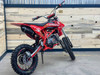 Denago MX3 Red Edition 140cc Pit Bike with bold red graphics, black powder-coated wheels, stainless steel exhaust, gold drive chain, and CNC anodized components for trail and off-road riding.