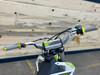 "The Denago MX3 Lime Edition pit bike features a 140cc engine with 4-speed transmission, hydraulic disc brakes, and adjustable suspension. Shown with vibrant lime green accents on CNC components, black powder-coated wheels, and aggressive knobby tires, this performance bike offers inverted forks, folding levers, and stainless exhaust. Perfect for serious trail riding with 14.5" ground clearance." "The Denago MX3 Lime Edition pit bike features a 140cc engine with 4-speed transmission, hydraulic disc brakes, and adjustable suspension. Shown with vibrant lime green accents on CNC components, black powder-coated wheels, and aggressive knobby tires, this performance bike offers inverted forks, folding levers, and stainless exhaust. Perfect for serious trail riding with 14.5" ground clearance."