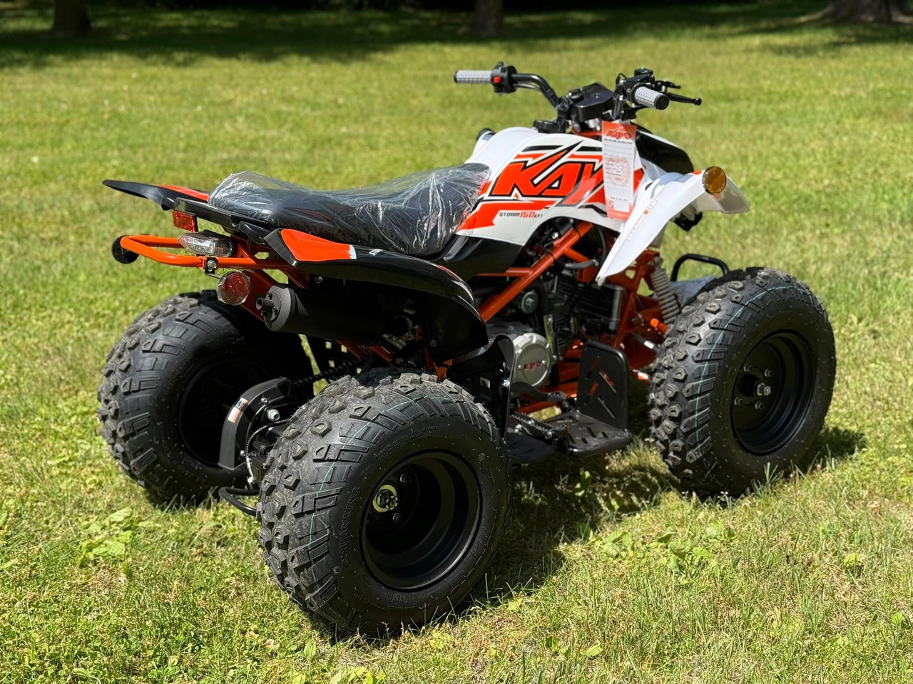 Kayo Storm 150 EFI ATV, a rugged and stylish all-terrain vehicle designed for off-road adventures. The ATV features a sleek black and red color scheme, with aggressive front tires, a double A-arm suspension system, and a sturdy frame. The image highlights the ATV's compact design, hydraulic disc brakes, and comfortable seat, making it an ideal choice for riders seeking performance and reliability on challenging terrains. Kayo Storm 150 EFI ATV, a rugged and stylish all-terrain vehicle designed for off-road adventures. The ATV features a sleek black and red color scheme, with aggressive front tires, a double A-arm suspension system, and a sturdy frame. The image highlights the ATV's compact design, hydraulic disc brakes, and comfortable seat, making it an ideal choice for riders seeking performance and reliability on challenging terrains.