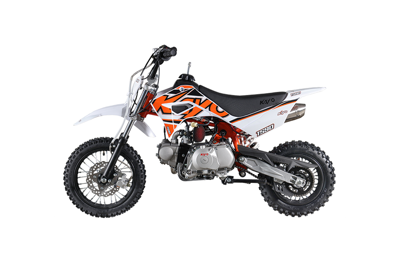 The image showcases the Kayo TS90 90cc Pit Bike, a sleek and agile off-road machine designed for riders of all skill levels. The bike features a compact and lightweight design with a 24.6-inch seat height, making it accessible to a wide range of riders. The 86cc 4-stroke engine and electric/kick start system are highlighted, emphasizing the bike's ease of use and reliability. The front and rear disc brakes are visible, showcasing the bike's safety features. The 12-inch front tire and 10-inch rear tire provide excellent traction and stability, while the conventional front forks and single rear shock ensure a smooth and comfortable ride. The low tack seat cover adds comfort and grip, and the 7-inch ground clearance allows the bike to tackle rough terrains with ease. Overall, the image captures the essence of a versatile, high-performing, and fun pit bike ready for any off-road adventure.