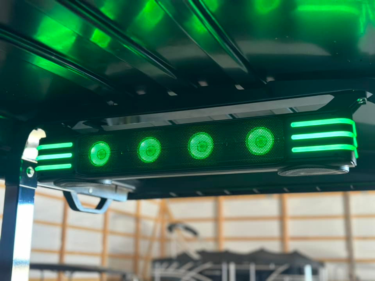 A close-up of the Premium Evolution Sound Bar shows its compact design with built-in speakers and woofers. The adjustable LED light modes sync with the music, creating a vibrant and immersive audio experience. The sound bar is wirelessly connected to the touchscreen, offering seamless control over your entertainment.