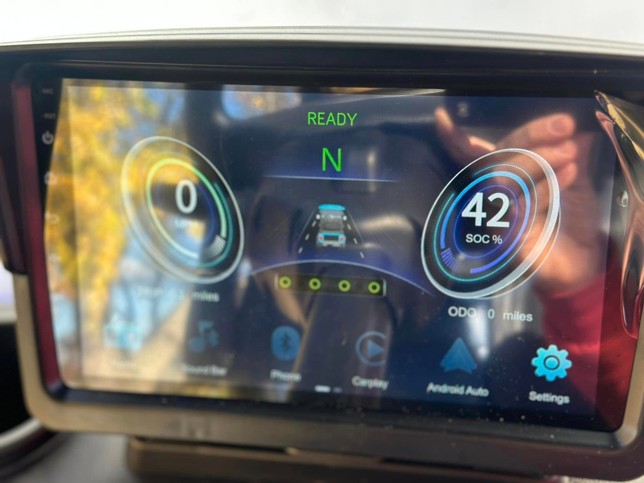 The centerpiece of the kart is the 9” multi-functional touchscreen, seamlessly integrated into the dashboard. The screen displays Apple CarPlay and Android Auto compatibility, along with speed, gear position, and lighting controls. Below the screen, you’ll find slideable air vents, dual-sized storage compartments, and USB charging ports for each seat. The two-tone luxury seats and ambient LED lighting create an elegant and futuristic interior.