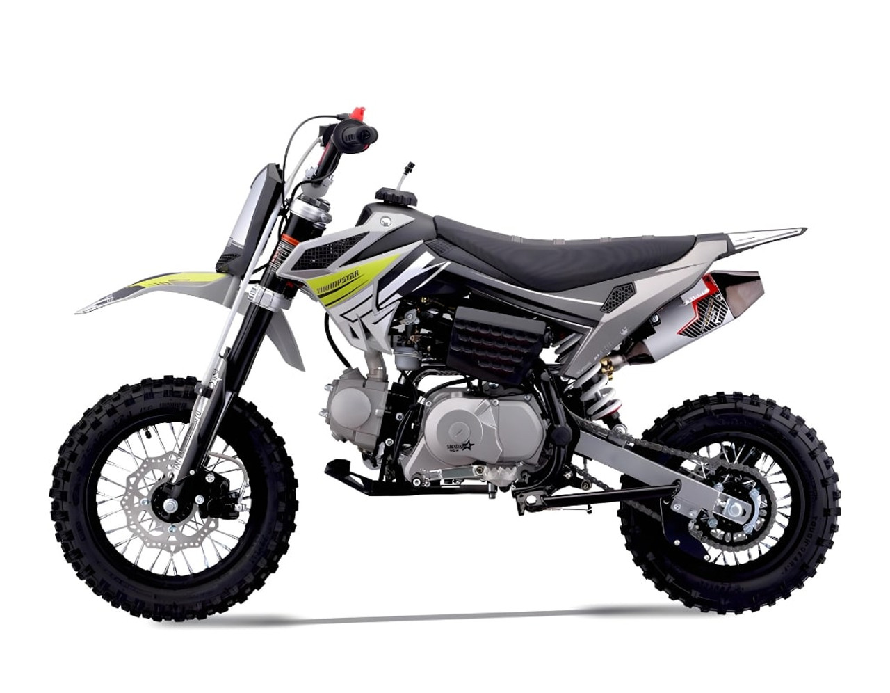 Thumpstar TSK 90cc mini bike, featuring its sleek mini stealth plastics, compact frame, and bold design. The bike is displayed in an action-ready stance, highlighting its inverted front suspension, oversized disc brakes, and Pipe Bomb muffler. The wrap-around frame and waterproof wiring are subtly visible, emphasizing the bike’s durability. The image also highlights the adjustable throttle limiter and emergency lanyard kill switch, key safety features for junior riders.