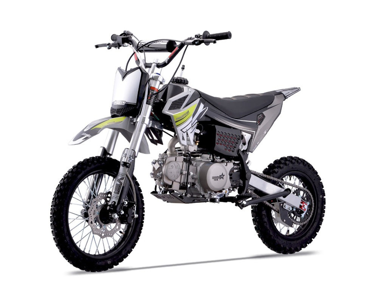 Thumpstar TSC 125 pit bike, highlighting its signature stealth plastics, wrap-around frame, and gripper striped seat. The bike is displayed in an action-ready stance, emphasizing its conventional front forks, rear mono shock, and front and rear disc brakes. The forged triple clamps and stator guard are subtly visible, underscoring the bike’s durability and safety features. The Mikuni VM22 carburetor and standard exhaust system are also highlighted, showcasing the bike’s performance enhancements.