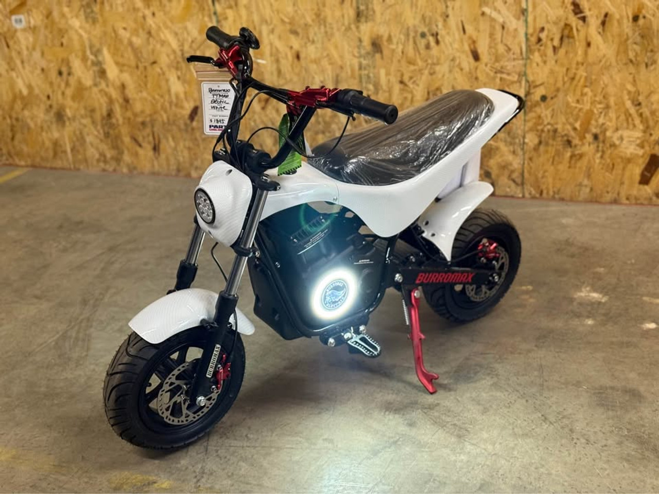 "The Burromax TT Max Supermoto electric bike features a 1500W brushless motor, 48V lithium battery, and 34+ mph top speed. With hydraulic disc brakes, supermoto tires, 4 ride modes, and LED lighting, this factory-upgraded performance machine delivers unmatched electric mini bike thrills. Includes handlebar gauge, USB ports, and 350 lb capacity."