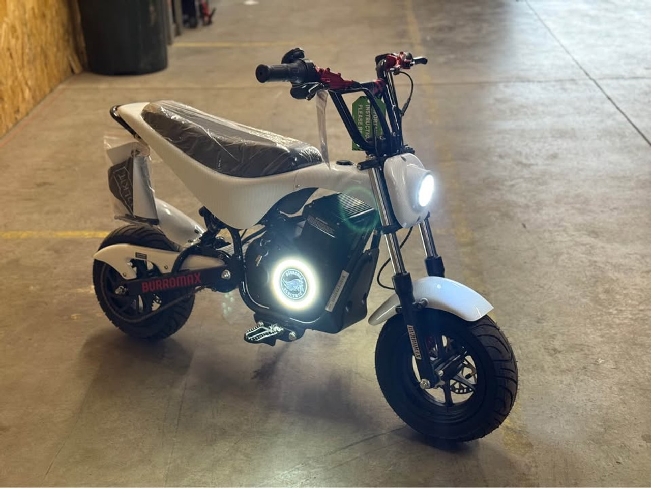 "The Burromax TT Max Supermoto electric bike features a 1500W brushless motor, 48V lithium battery, and 34+ mph top speed. With hydraulic disc brakes, supermoto tires, 4 ride modes, and LED lighting, this factory-upgraded performance machine delivers unmatched electric mini bike thrills. Includes handlebar gauge, USB ports, and 350 lb capacity."
