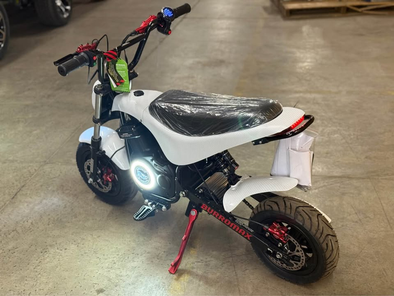 "The Burromax TT Max Supermoto electric bike features a 1500W brushless motor, 48V lithium battery, and 34+ mph top speed. With hydraulic disc brakes, supermoto tires, 4 ride modes, and LED lighting, this factory-upgraded performance machine delivers unmatched electric mini bike thrills. Includes handlebar gauge, USB ports, and 350 lb capacity."