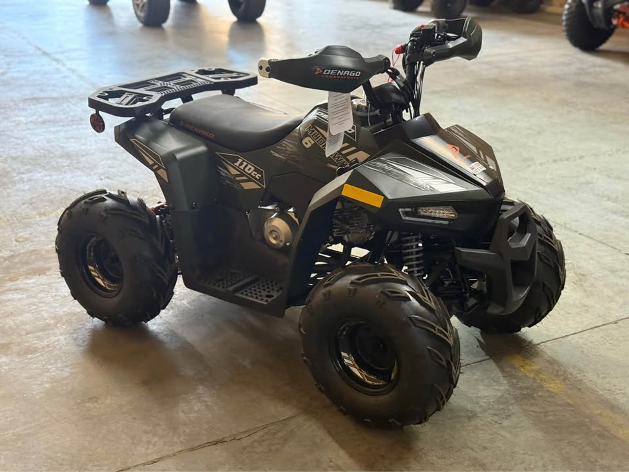 Matte green Denago Mudhawk 6 youth ATV with 107cc 4-stroke engine, automatic F-N-R transmission, LED headlights, rear cargo rack, independent front suspension, and remote wireless shut-off for kids aged 6 and up.