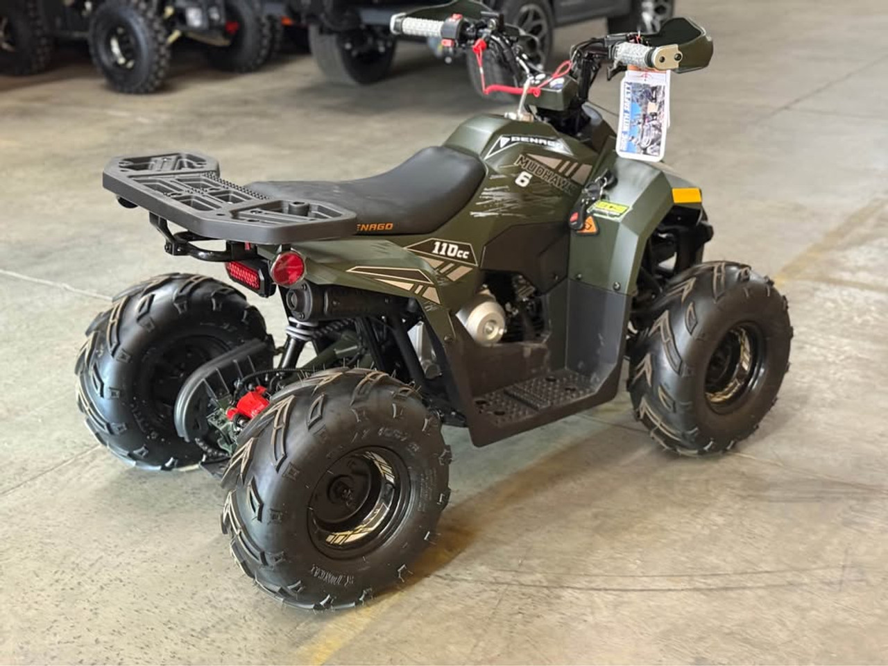 Matte green Denago Mudhawk 6 youth ATV with 107cc 4-stroke engine, automatic F-N-R transmission, LED headlights, rear cargo rack, independent front suspension, and remote wireless shut-off for kids aged 6 and up.