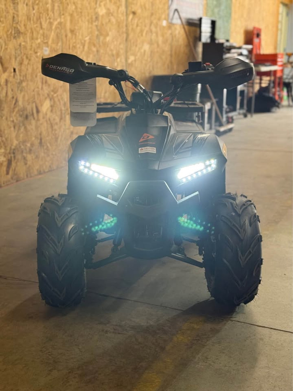 Matte green Denago Mudhawk 6 youth ATV with 107cc 4-stroke engine, automatic F-N-R transmission, LED headlights, rear cargo rack, independent front suspension, and remote wireless shut-off for kids aged 6 and up.
