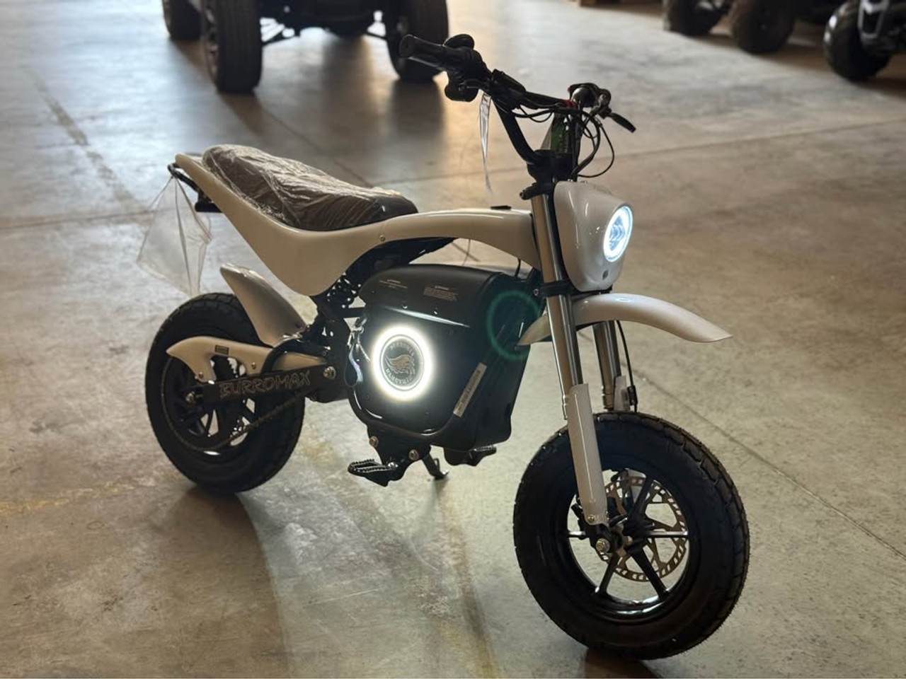 "The Burromax TT1600R electric super bike features a 1600W brushless motor, 52V lithium battery, and 32 mph top speed. With hydraulic disc brakes, premium suspension, LED lighting, and 350 lb capacity, this full-size electric motorcycle delivers professional performance. Includes 4 ride modes, USB ports, and 30-mile range."