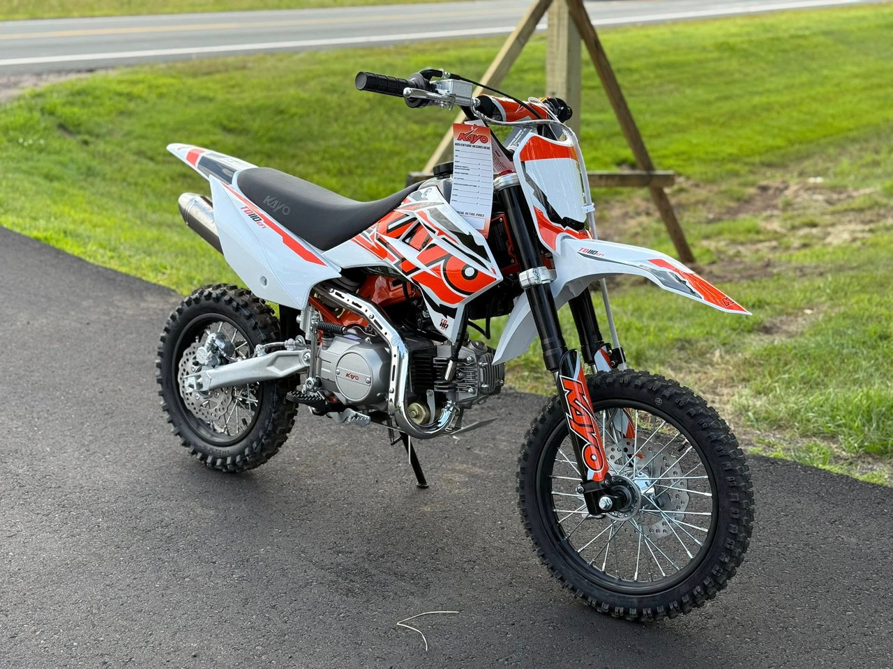 The Kayo TD110 EFI Pit Bike features a sleek, aggressive design with a black and red color scheme, inverted front forks, knobby off-road tires, and a high-mounted exhaust. The EFI fuel system, hydraulic disc brakes, and reinforced steel frame make this mini dirt bike a top choice for performance-oriented riders