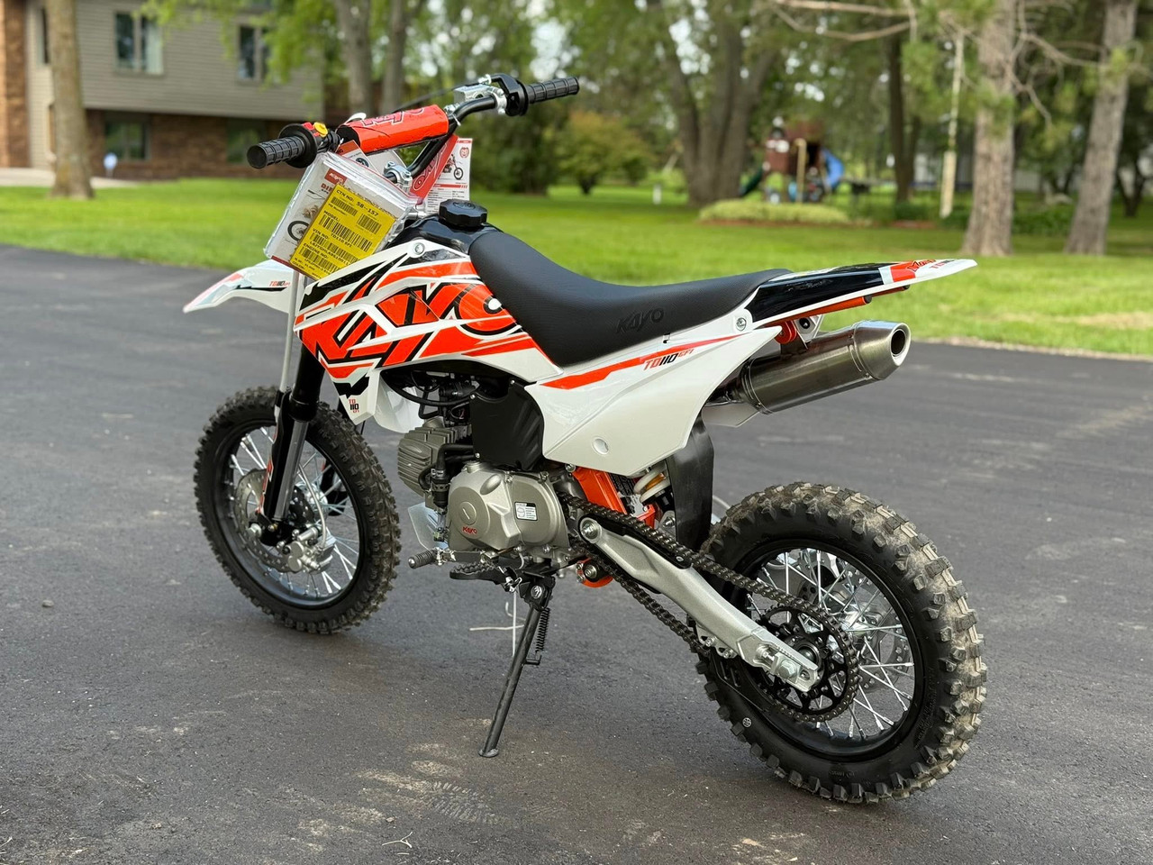 The Kayo TD110 EFI Pit Bike features a sleek, aggressive design with a black and red color scheme, inverted front forks, knobby off-road tires, and a high-mounted exhaust. The EFI fuel system, hydraulic disc brakes, and reinforced steel frame make this mini dirt bike a top choice for performance-oriented riders